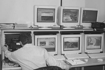 Figure 4 - In this figure, a control room operator is monitoring six computers, each of which shows a live image from the work zone. This is the central control room used for monitoring the Big I.
