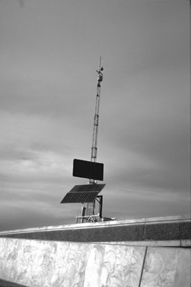 Figure 3 - This figure shows a sensor trailer, antenna for wireless communications, and a solar panel for battery charging. This trailer was one of the system trailers used to detect traffic conditions around the Big I.